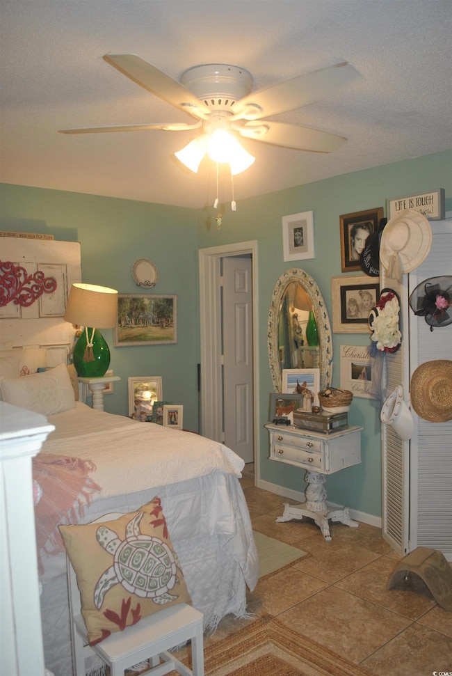 Tiled bedroom with ceiling fan