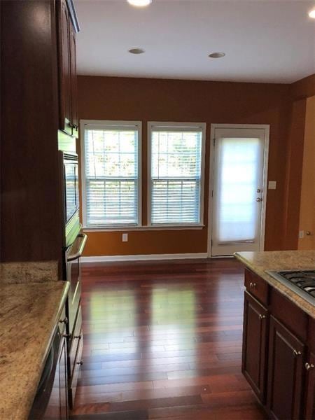 Kitchen featuring light stone countertops, plenty 