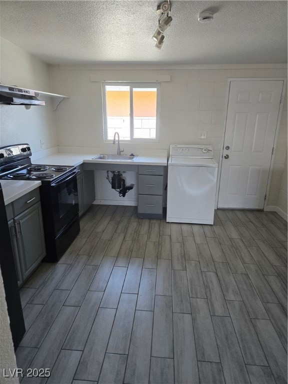 Washroom with washer / dryer, wood finished floors