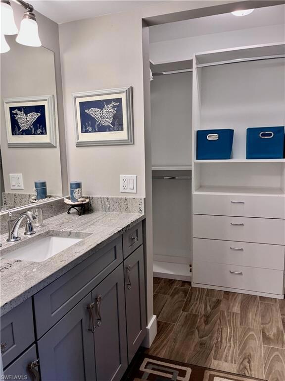 Large walk in closet with a single vanity