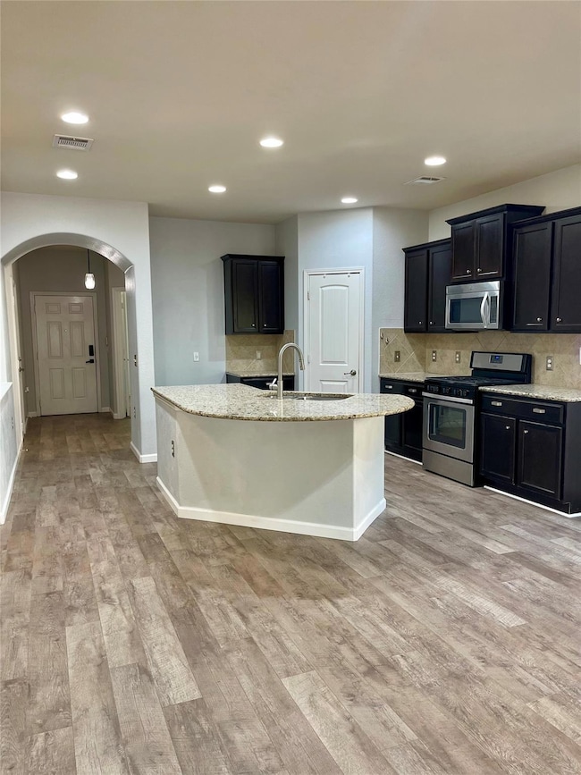 Kitchen with tasteful backsplash, appliances with