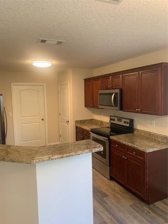 Spacious Kitchen Featuring Bartop Peninsula