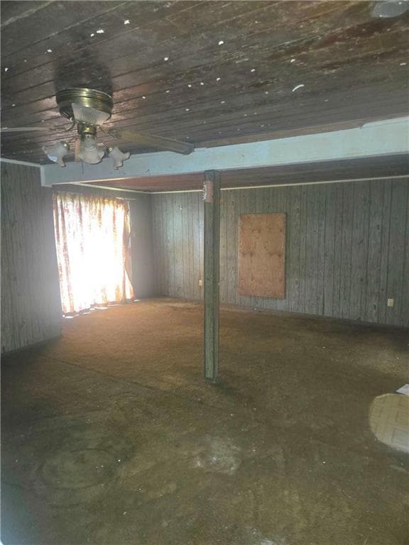 Basement featuring wood walls