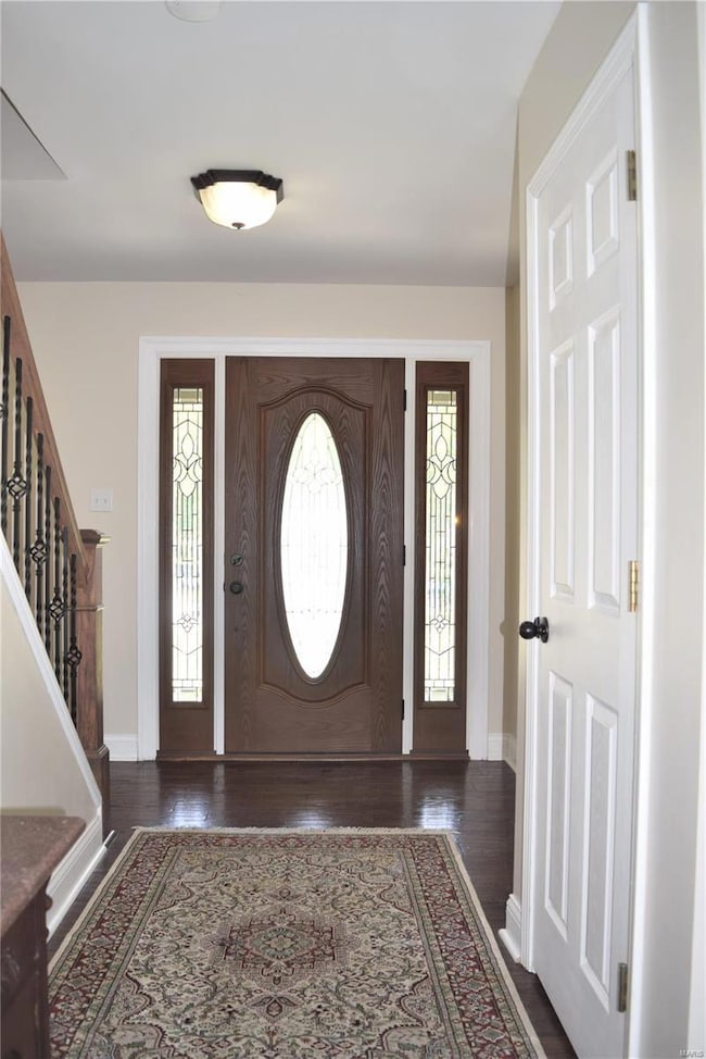 Entry foyer.  Greeted by a newer leaded glass door