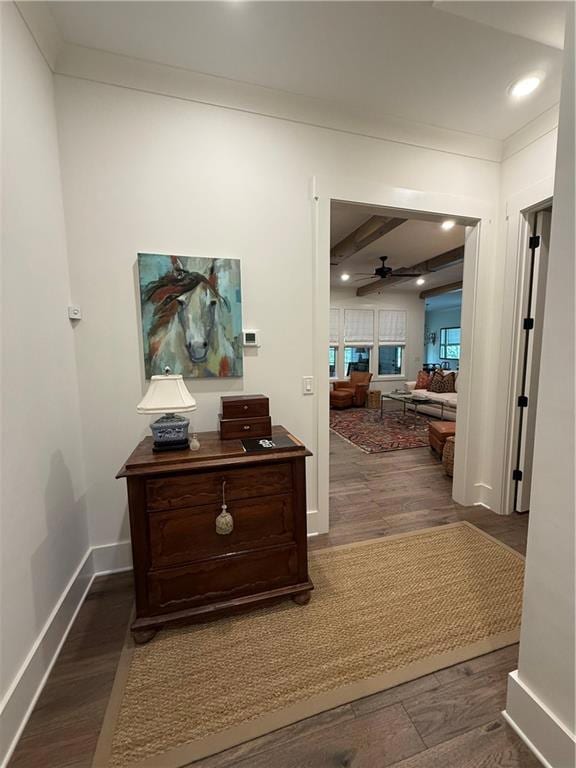 Hall featuring wood finished floors, beam ceiling,