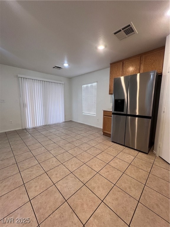Kitchen featuring fridge, recessed lighting, brown
