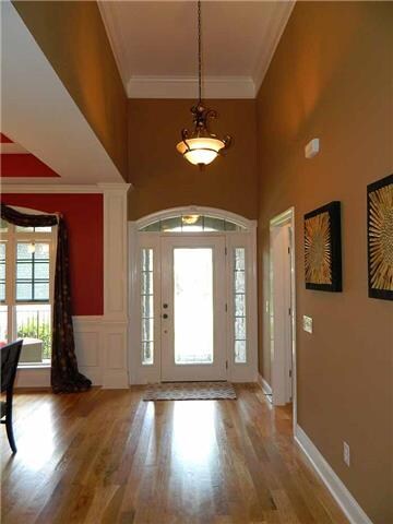 Entry Foyer: Inviting hardwood entry with soaring 