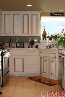 Kitchen has been updated with tile floors, stainle