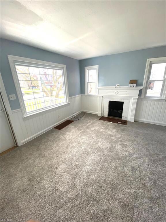 Living room with newer carpet and decorative firep