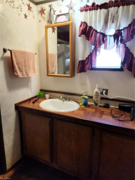 Bathroom featuring mirror and vanity