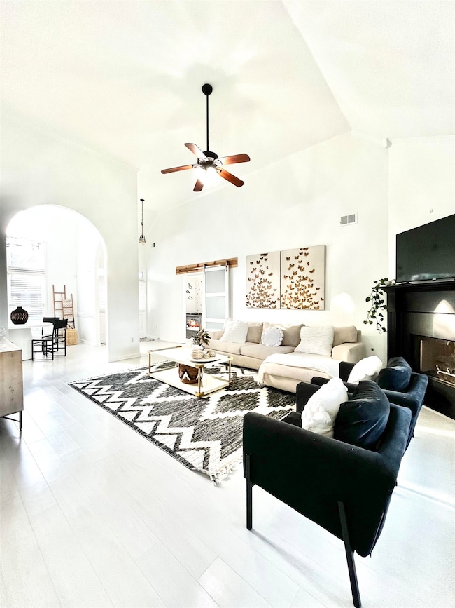 Living room featuring a fireplace, light hardwood 
