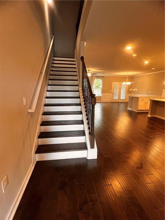 Staircase featuring hardwood / wood-style floors, baseboards, and recessed lighting