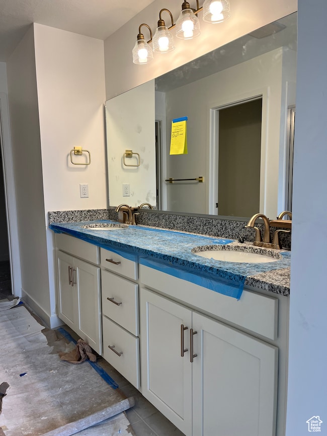 Full bathroom with double vanity and tile patterned floors