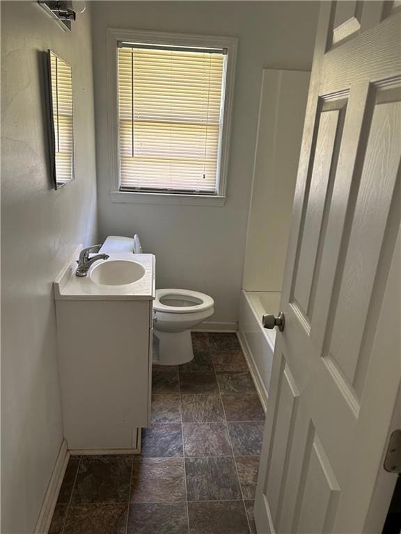 Full bathroom featuring stone tile floors and vanity