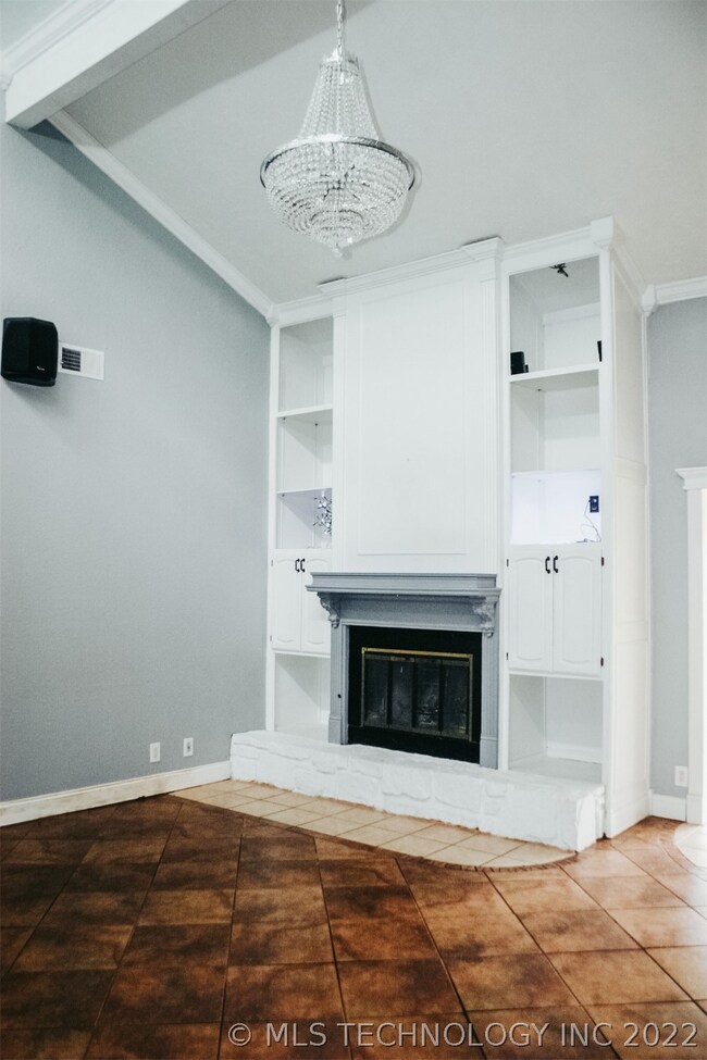Beautiful fireplace with built ins and lighting.