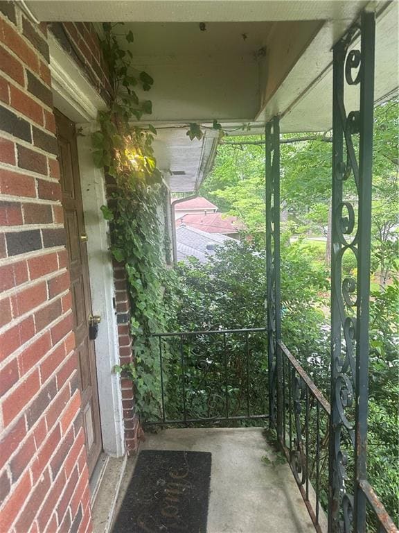 View of exterior entry featuring brick siding