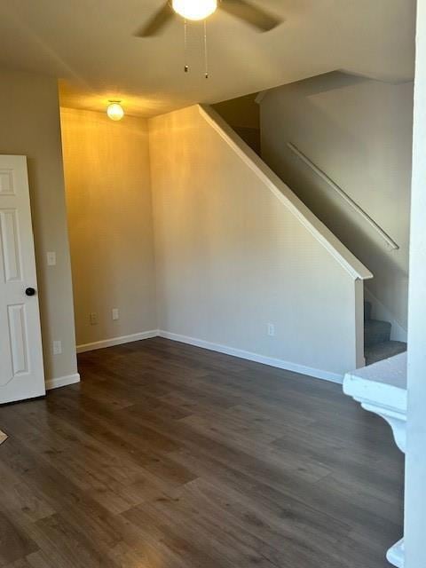 Unfurnished living room featuring ceiling fan, dar