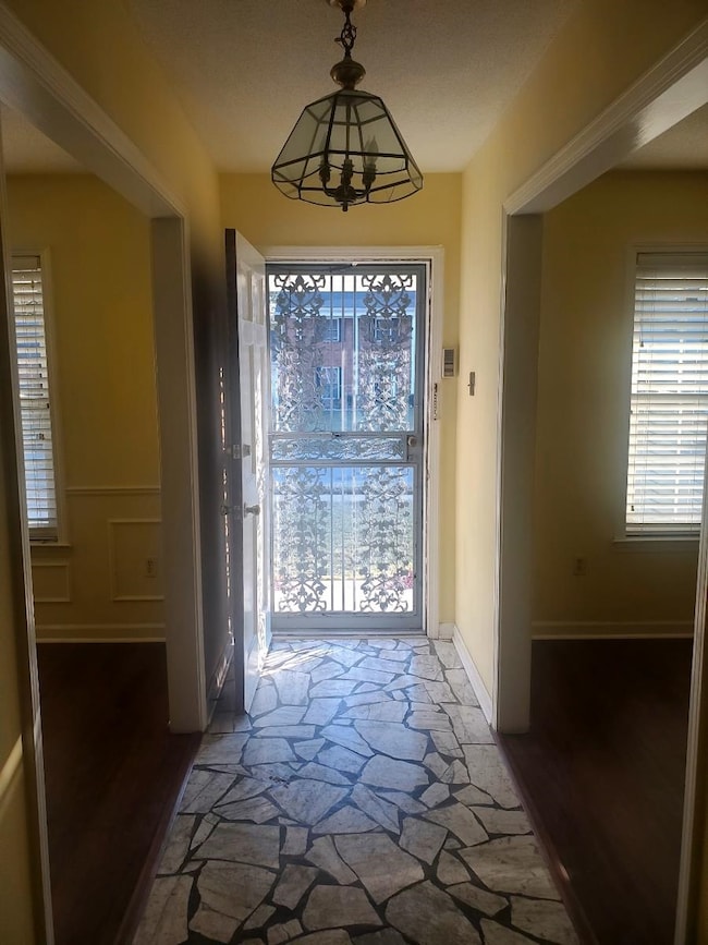 Doorway featuring dark wood-type flooring and a no
