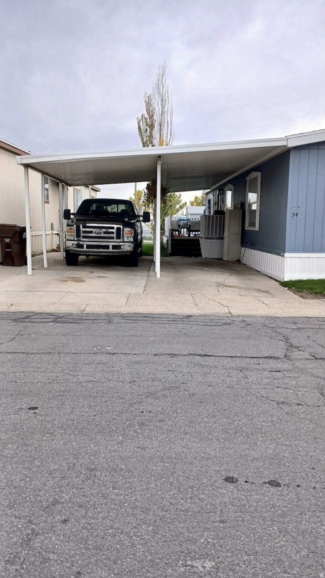 View of parking featuring a carport and concrete driveway