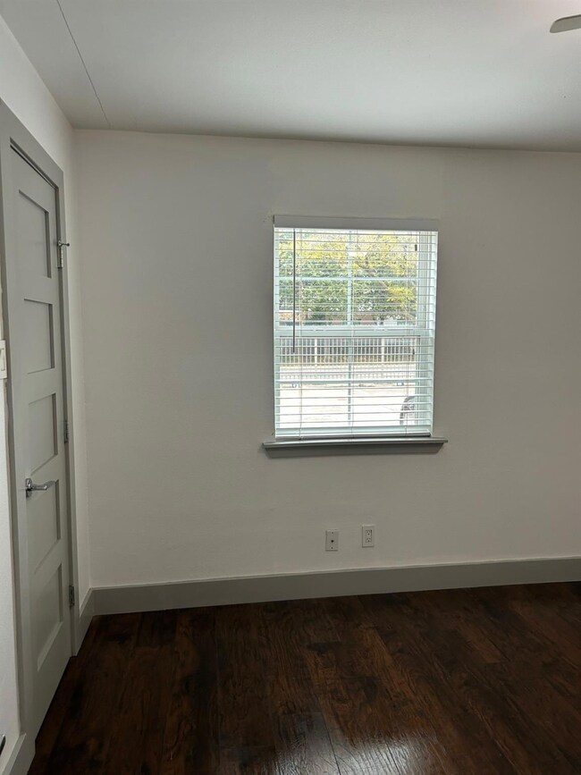 Spare room with dark wood finished floors and base
