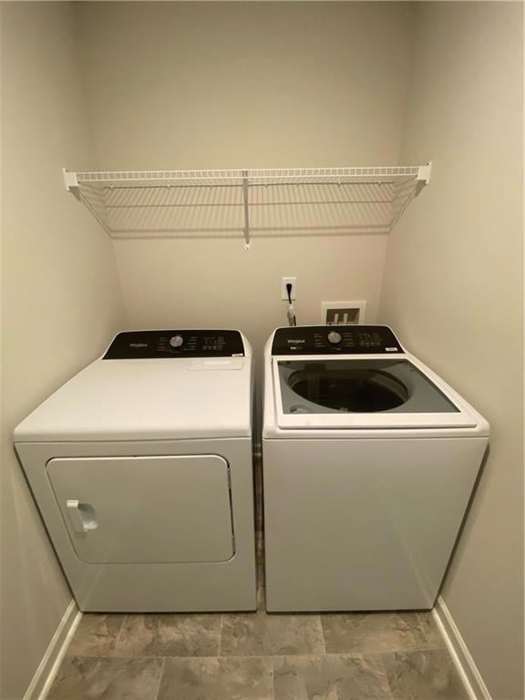 Washroom featuring washer and dryer and laundry ar