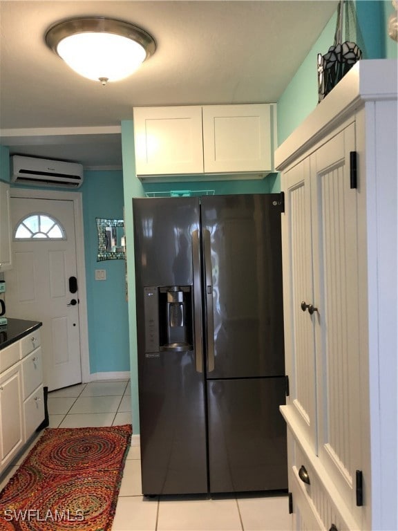 Kitchen featuring a wall mounted AC, white cabinet