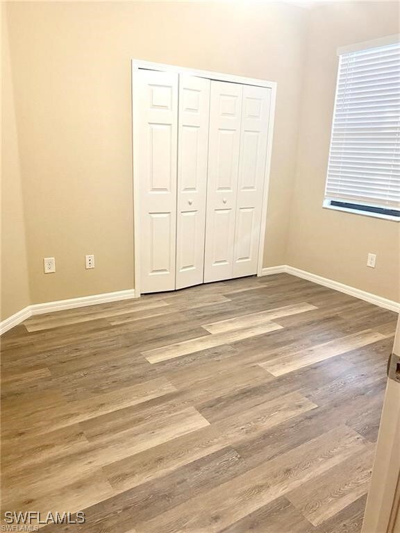 Unfurnished bedroom featuring baseboards, wood fin