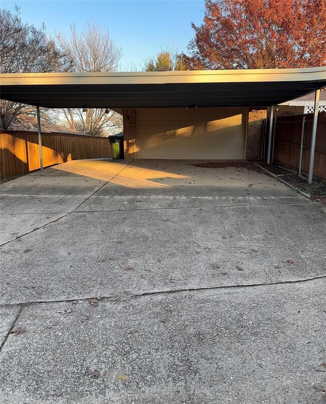 View of car parking featuring a carport