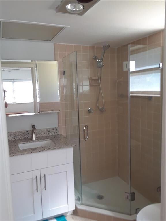 Master bath with new vanity, toilet and glass show