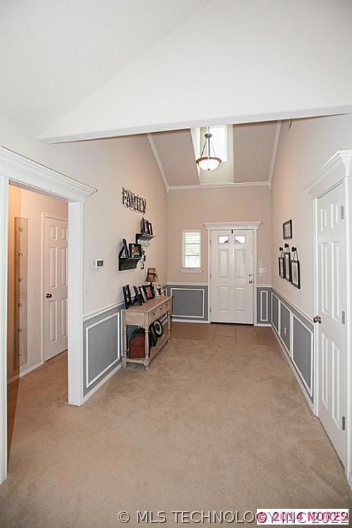 Wide entry with dormer window above, letting in lo