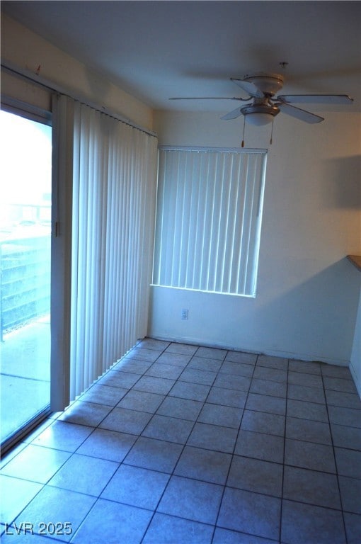 Tiled empty room featuring ceiling fan