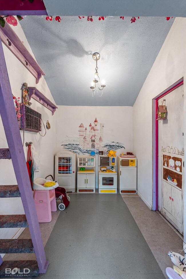 Rec room with concrete floors, a textured ceiling,