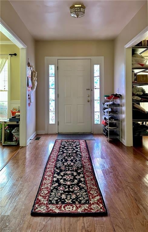Entryway with healthy amount of natural light and hardwood / wood-style floors