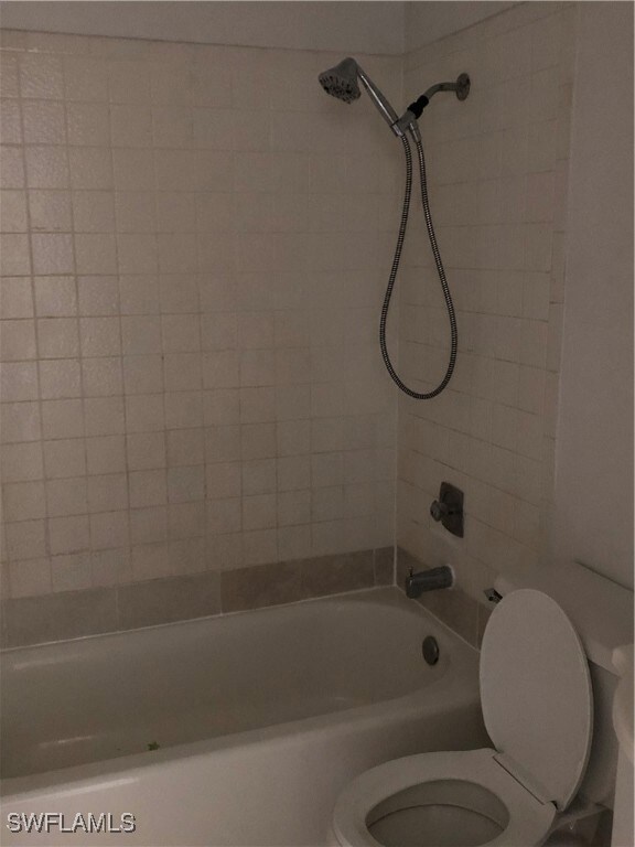 Full bathroom featuring toilet and shower / bathtu