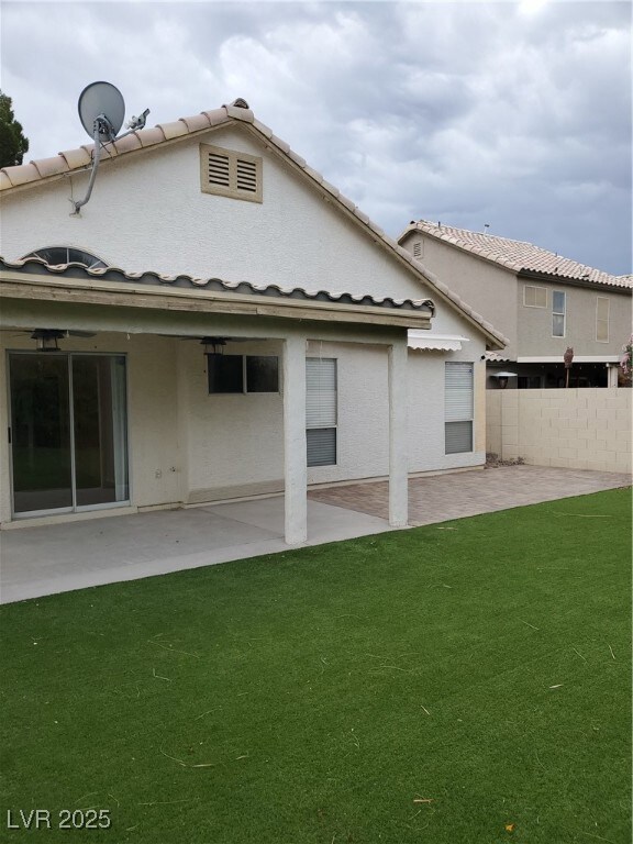 Rear view of house with a patio and stucco siding