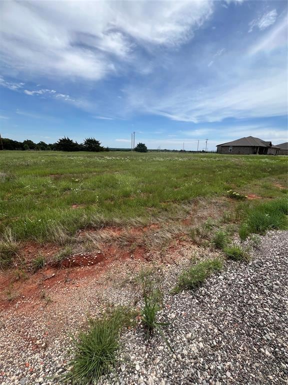 View of yard with a rural view