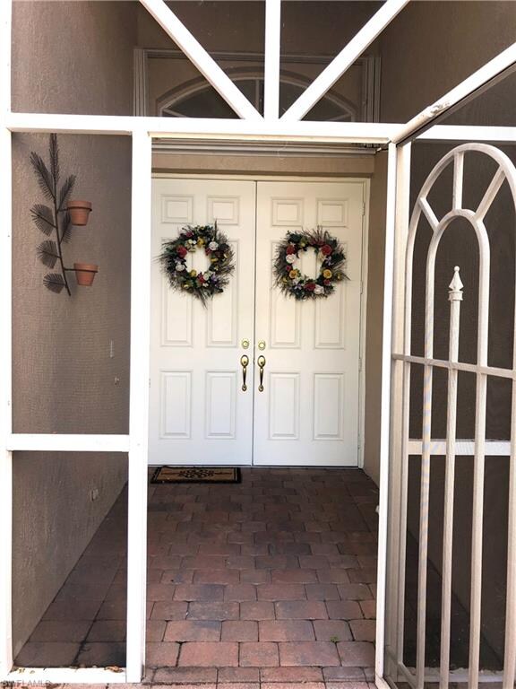 Paver stone entrance with lovely double doors