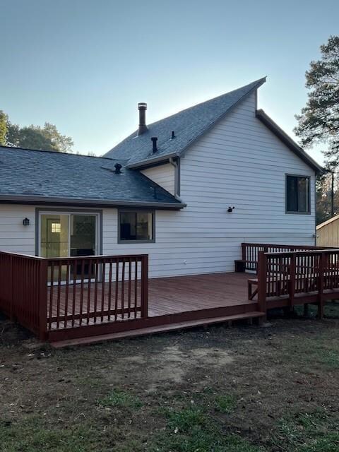Back of house with a deck