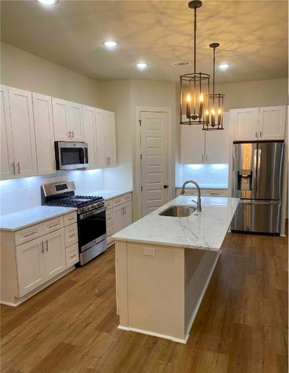 This photo demonstrates the designer's special touches with an extra tall pantry door to match the 10-foot ceilings throughout the kitchen and living room space. This kitchen shows stainless steel appliances; however you will have a choice of finishe