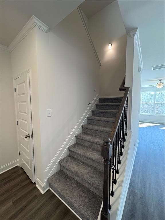 Hallway featuring light carpet, an upstairs landin