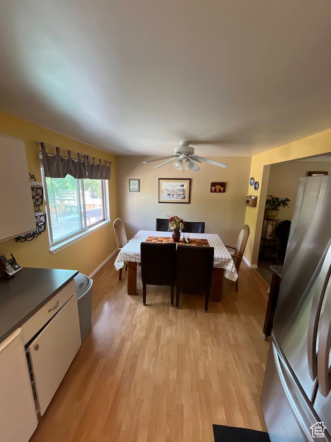 Dining space with light wood-type flooring and ceiling fan