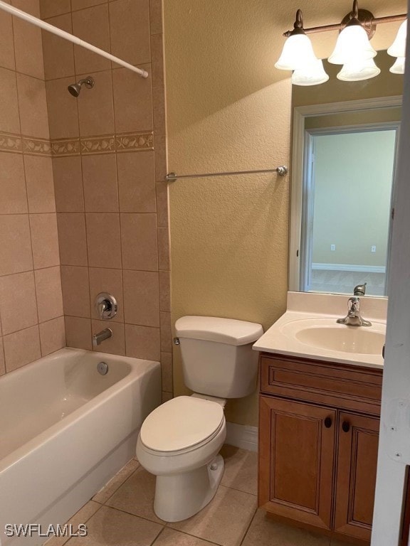 Bathroom with toilet, vanity, tile patterned floor