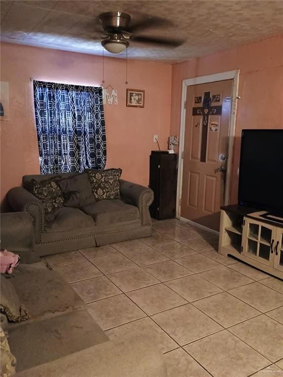 Living room featuring light tile patterned floors and ceiling fan