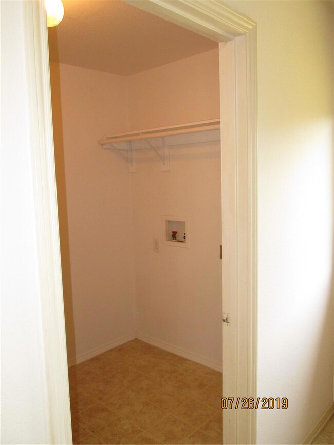 Laundry room featuring light tile patterned flooring and washer hookup