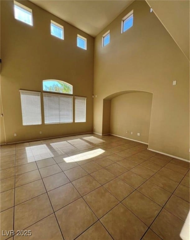 Empty room featuring tile patterned flooring, a hi