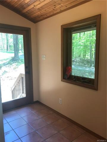 Entrance foyer with tile flooring and vaulted wood ceilings