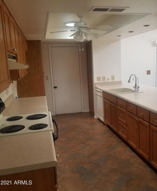 Kitchen has newer oak cabinets, counters