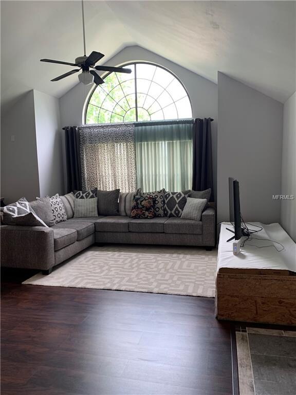 Living room with vaulted ceiling and ceiling fan