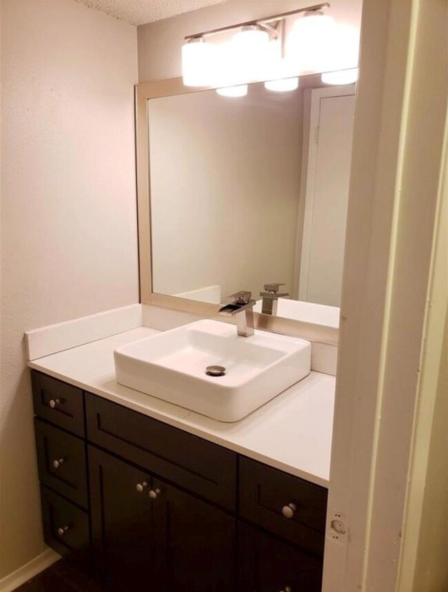 Bathroom featuring vanity and a textured ceiling