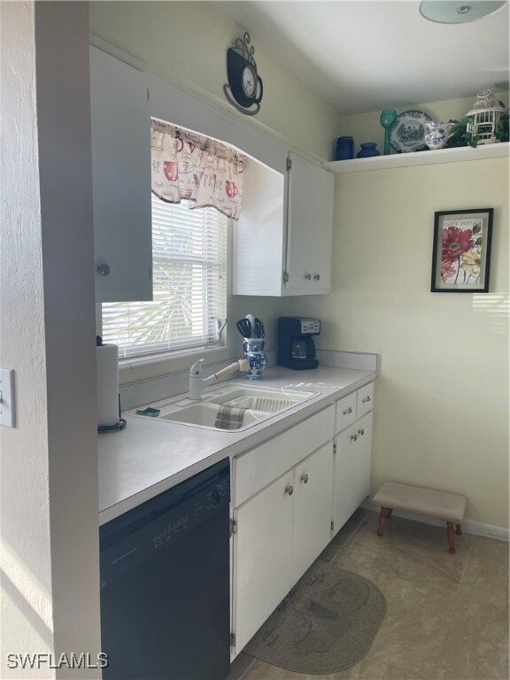 Kitchen featuring dishwashing machine, tile patter